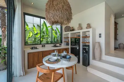 a kitchen with a white table and chairs and a window at Casa Vera - Delightful 1-Bedroom Villas in the Heart of Umalas in Canggu