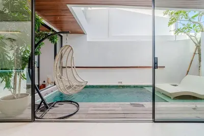 a swimming pool with a hammock in a house at Casa Estella Stunning 2BR in Umalas Canggu in Kerobokan