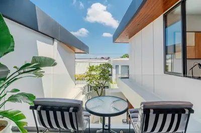 a balcony with a table and two chairs at Casa Estella Stunning 2BR in Umalas Canggu in Kerobokan
