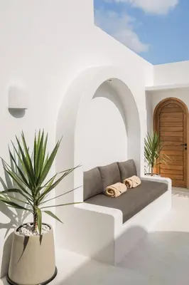 a couch in a white room with a potted plant at Villa Casa Gaia 2 by BaliSuperHost in Kerobokan