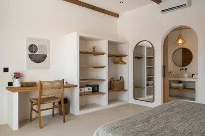 a bedroom with a bed and a desk and a mirror at Villa Casa Gaia 2 by BaliSuperHost in Kerobokan