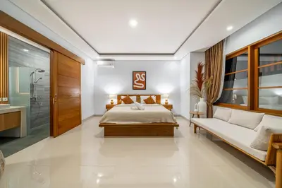 a bedroom with a bed and a bath room at Sofia 1- Luxurious 2BR Villa with Private Pool in Canggu