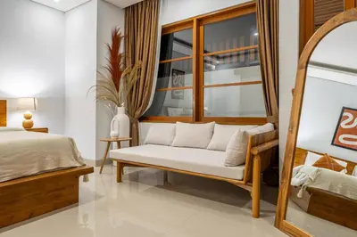 a bedroom with a bed and a mirror at Sofia 1- Luxurious 2BR Villa with Private Pool in Canggu