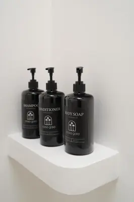 three bottles of soap sitting on a shelf at Villa Casa Gaia 3 by BaliSuperHost in Kerobokan