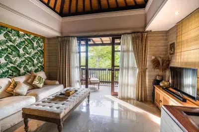 a living room with a couch and a television at The Springs Villas Jimbaran in Jimbaran