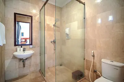 a bathroom with a shower and a toilet and a sink at PRIVATE 3BR - Yash Villa at Seminyak in Kerobokan
