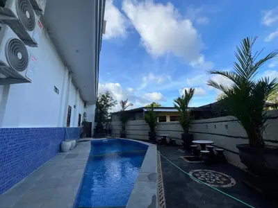 a swimming pool in the backyard of a building at Kubu Celagi Manis in Jimbaran