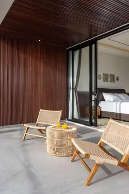 a room with two chairs and a bed and a table at Pristine & Modern Gem Luxury 3bd Villa in Umalas in Kerobokan