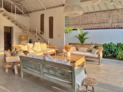a living room with couches and a table at Villa Rocher - Modern 3 BR Villa Batu Belig 3 min beach in Seminyak