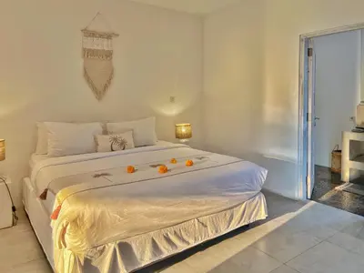 a bedroom with a large bed with oranges on it at Villa Rocher - Modern 3 BR Villa Batu Belig 3 min beach in Seminyak