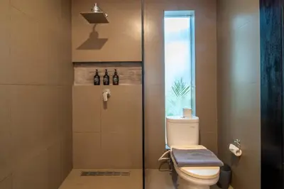 a bathroom with a toilet and a glass shower at Villa Eleni - Your Private Oasis in Seminyak - A Hosted Luxury Boutique Villa in Seminyak