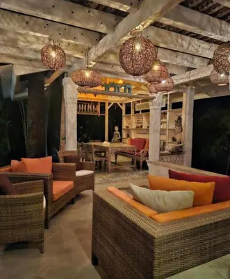 a lobby with couches and chairs and a bar at Villa Gadja Bali in Jimbaran