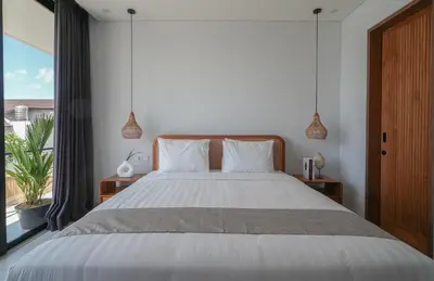 a bedroom with a large bed and a large window at Shanti Villa - 3BR Luxury in Seminyak in Badung