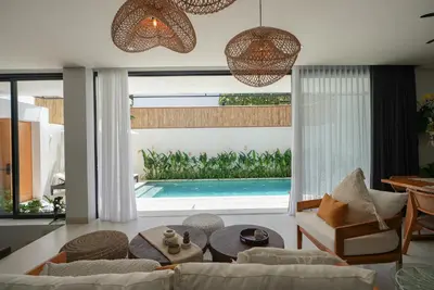 a living room with a couch and a swimming pool at Shanti Villa - 3BR Luxury in Seminyak in Badung