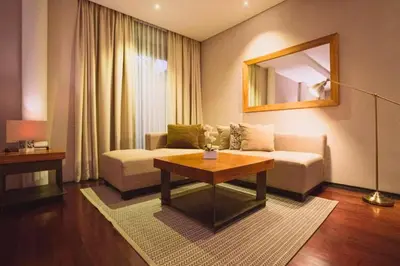 a living room with a couch and a table at Jivala 1 BR Private Pool Villa in Seminyak