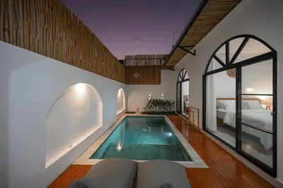 a house with a swimming pool in the middle of a room at Eunoia Villa in Jimbaran