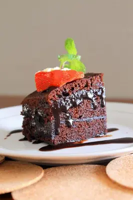 a piece of chocolate cake on a plate at Rofa Kuta Hotel - CHSE Certified in Legian
