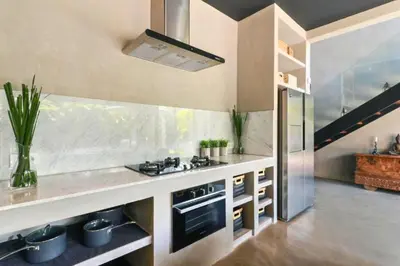 a kitchen with a sink and a stove in it at Saanvi 2 BR Private Pool Villa in Canggu