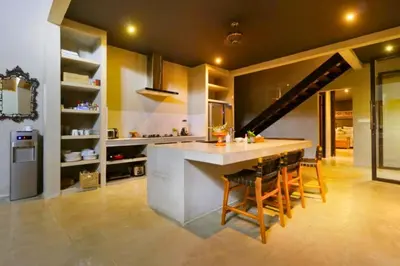 a kitchen with a large island in the middle at Saanvi 2 BR Private Pool Villa in Canggu