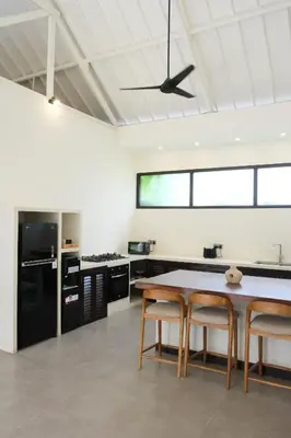 a kitchen with a table and two chairs at Uma dharma villas in Seminyak