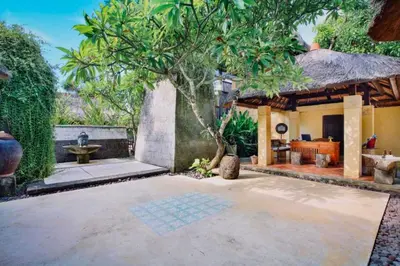 a courtyard of a house with a tree at Vainavi 1 BR Private Pool Villa in Sanur