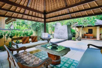 an outdoor living room with a table and chairs at Vainavi 1 BR Private Pool Villa in Sanur
