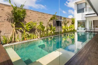 a swimming pool in front of a house at Lashana 3 BR Private Pool Villa in Legian
