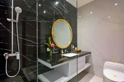 a bathroom with a sink and a mirror at Lashana 3 BR Private Pool Villa in Legian
