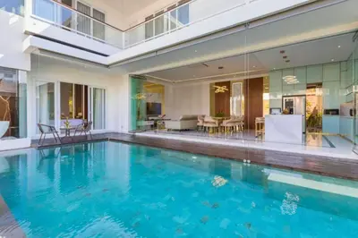 a swimming pool in the middle of a house at Nayana 4 BR Private Pool Villa in Legian