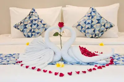 two swans sitting on top of a bed at Nayana 4 BR Private Pool Villa in Legian