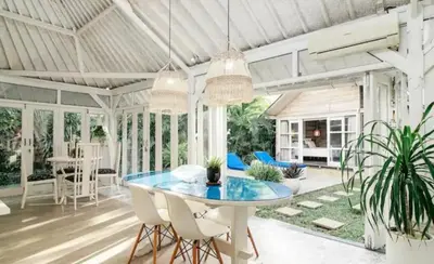 a dining room with a blue table and chairs at Villa 9C in Seminyak