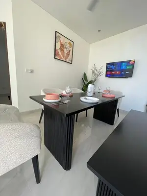a living room with a table and a couch at CASA NOOA Kerobokan in Kerobokan