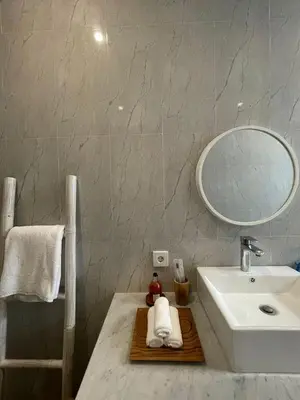 a bathroom with a sink and a mirror at CASA NOOA Kerobokan in Kerobokan