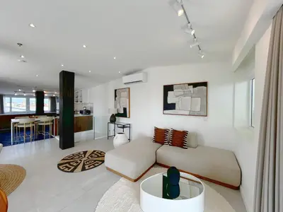 a living room with a couch and a table at The Cruise Berawa - Design Apartments & Penthouses by CPM Bali in Canggu