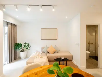 a living room with a couch and a table at The Cruise Berawa - Design Apartments & Penthouses by CPM Bali in Canggu