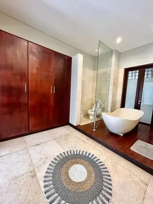 a large bathroom with a tub and a sink at MJ Orchid Residence in Seminyak