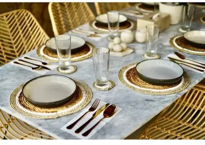 a table with plates and glasses on a table at Villa J in Nusa Dua