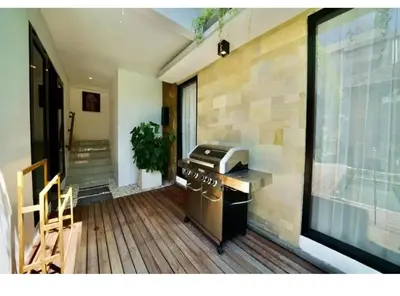 a kitchen with a stove and a large window at Villa J in Nusa Dua