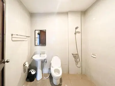 a bathroom with a toilet and a sink at arimanu rooms in Kuta