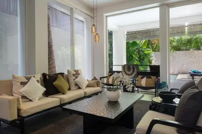 a living room with a couch and a table at Villa Levi by GORO in Seminyak