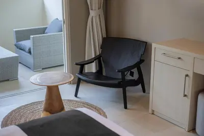 a black chair in a living room with a table at Villa Levi by GORO in Seminyak