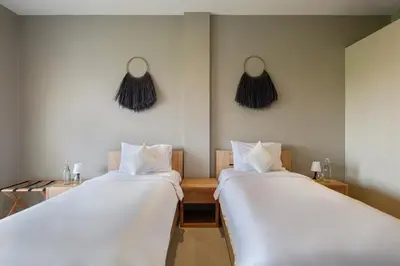 two beds sitting next to each other in a room at Villa Levi by GORO in Seminyak