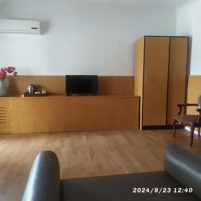 a room with a flat screen tv on a wooden cabinet at Private villa with swimming pool in Kuta