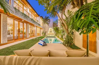 an exterior view of a house with a swimming pool at Villa Aztec - 6BDR private pool and garden in Seminyak