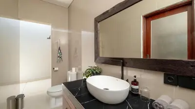 a bathroom with a sink and a mirror at Villa Lange 2 by Villa Finder in Seminyak