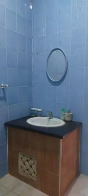 a bathroom with a sink and a mirror at Village Pool Private In Kuta Bali in Legian