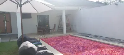 a living room with an umbrella and a rug at Village Pool Private In Kuta Bali in Legian