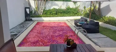 a large pile of red petals on a patio at Village Pool Private In Kuta Bali in Legian