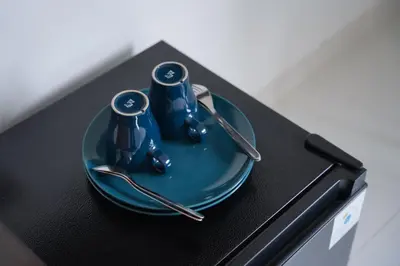 a blue plate with silverware on top of a table at Jabu Hasian Bali in Kerobokan