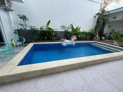 a small swimming pool with a toy horse sitting next to it at Jabu Hasian Bali in Kerobokan